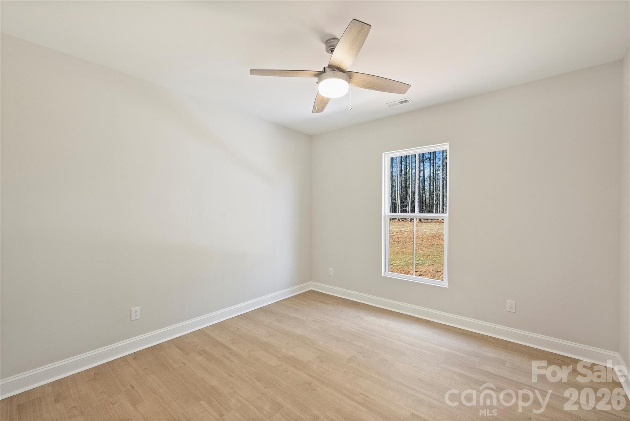 2307 Lee Lawing Road Lincolnton, NC 28092 - Photo 32 of 42 an empty room with a window and ceiling fan