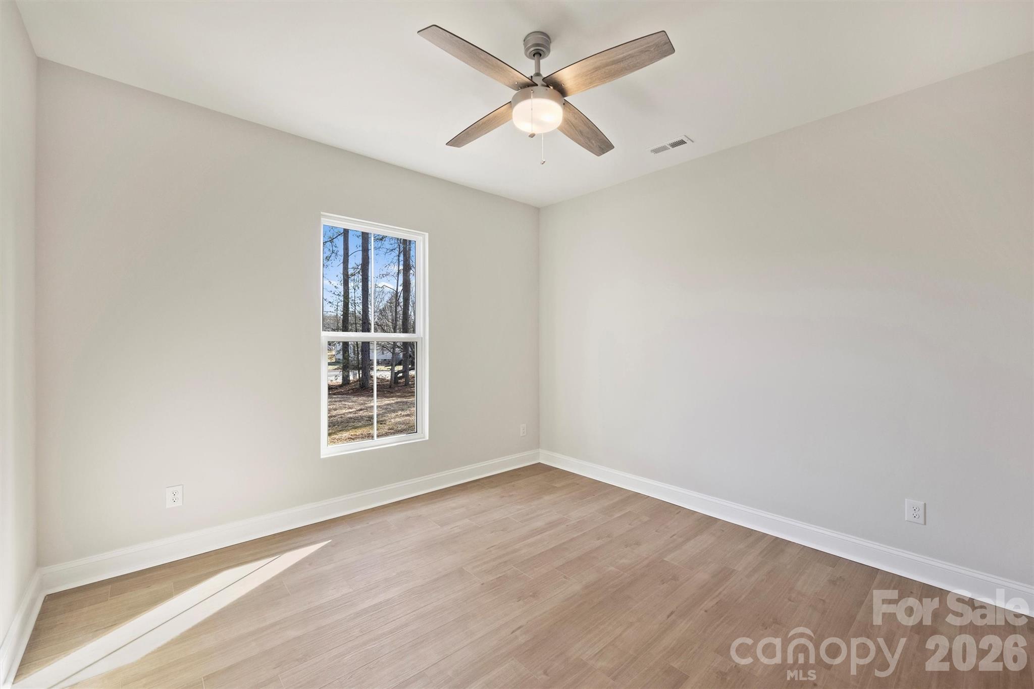 2307 Lee Lawing Road Lincolnton, NC 28092 - Photo 33 of 42 wooden floor in an empty room with a window