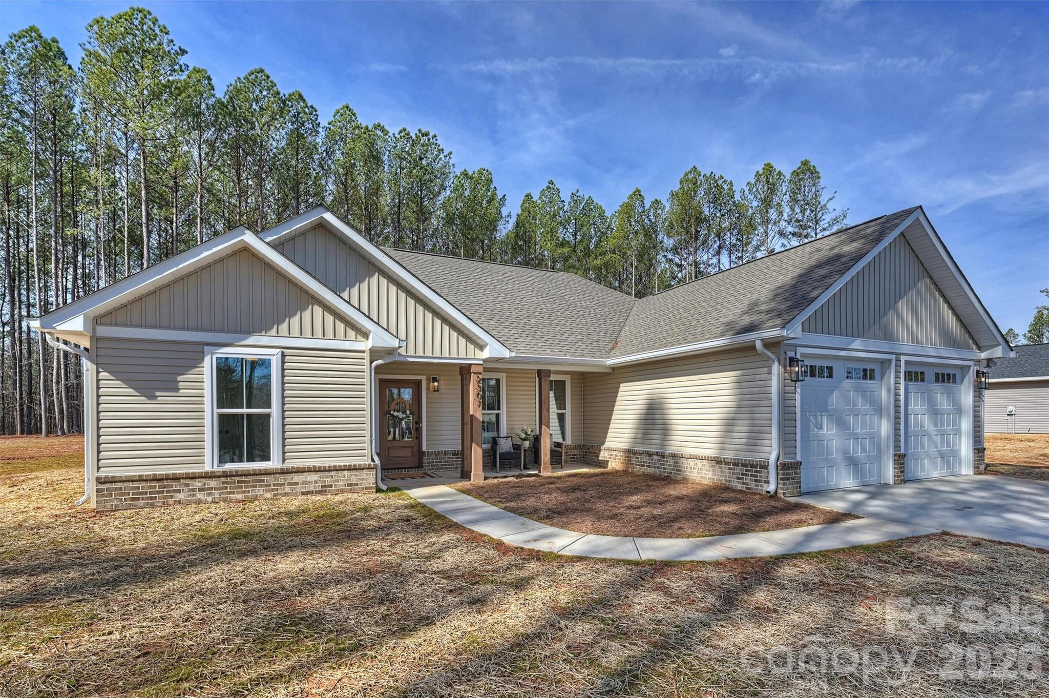 2307 Lee Lawing Road Lincolnton, NC 28092 - Photo 5 of 42 a front view of a house with a yard and trees