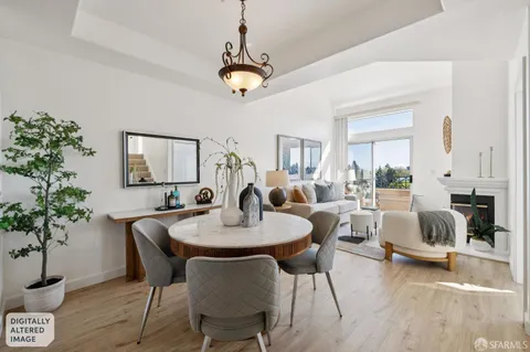 a living room with furniture potted plant and a chandelier
