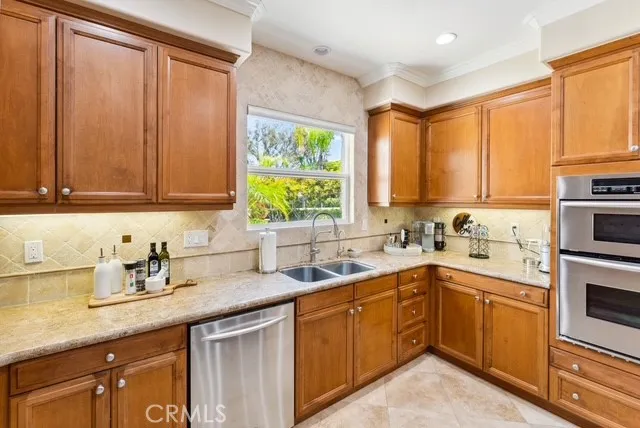 a kitchen with a sink stove top oven and cabinets