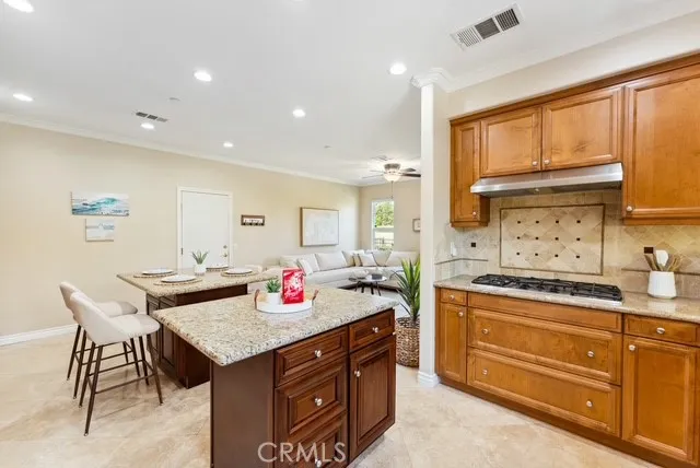 a kitchen with a stove a sink dishwasher and a refrigerator with wooden cabinets