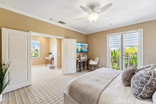 a bedroom with a large bed a desk and chair