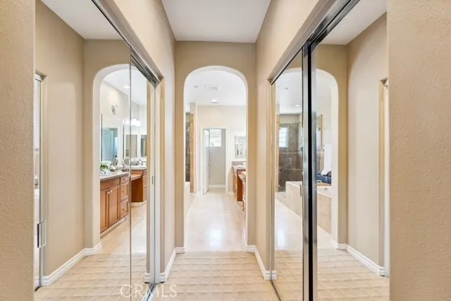a bathroom with a tub a sink and a large mirror