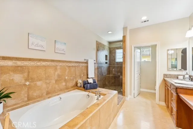 a large bathroom with a double vanity sink a large mirror and shower