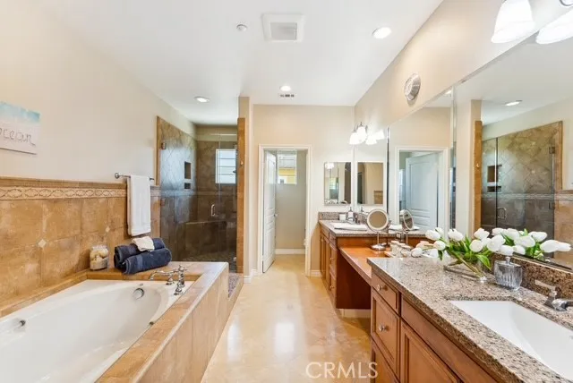 a bathroom with a sink double vanity granite and a mirror