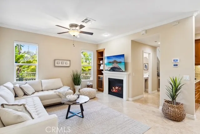 a living room with furniture fireplace and a window