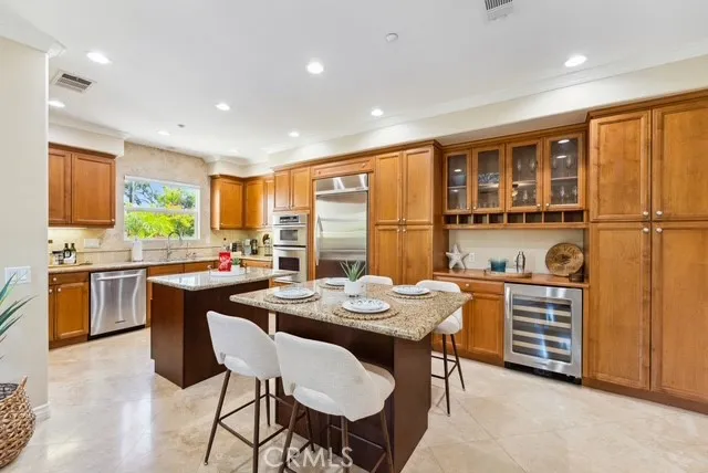 a kitchen with a stove a sink a dining table and chairs