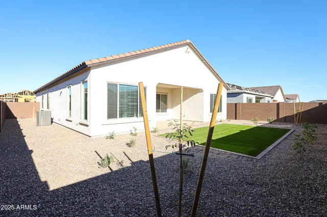 a view of a house with backyard and sitting area