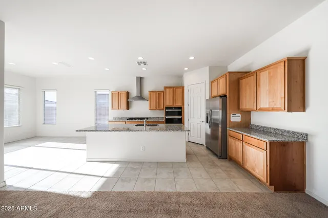a large kitchen with stainless steel appliances lots of counter space and a sink