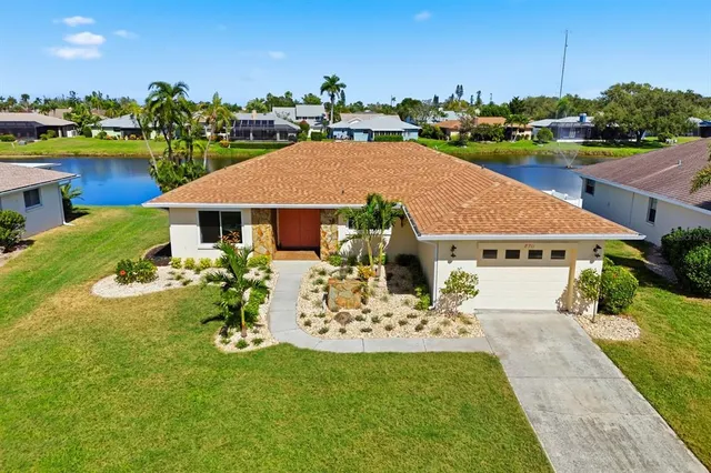 a view of a house with garden and a sitting area