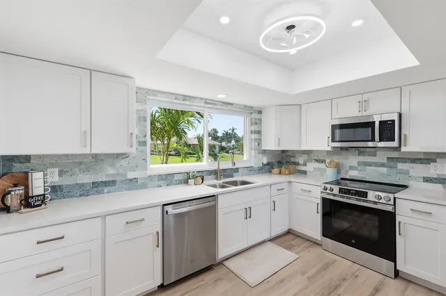 a kitchen with a sink stove and microwave