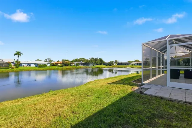 a view of a lake with houses in the back
