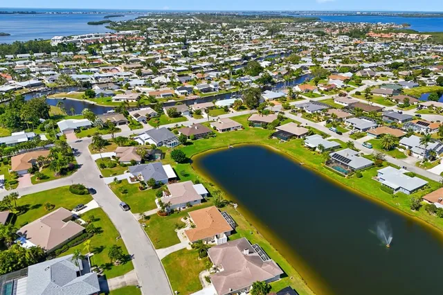 an aerial view of residential houses with outdoor space and swimming pool