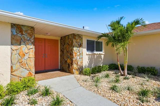 a front view of yellow house with shower