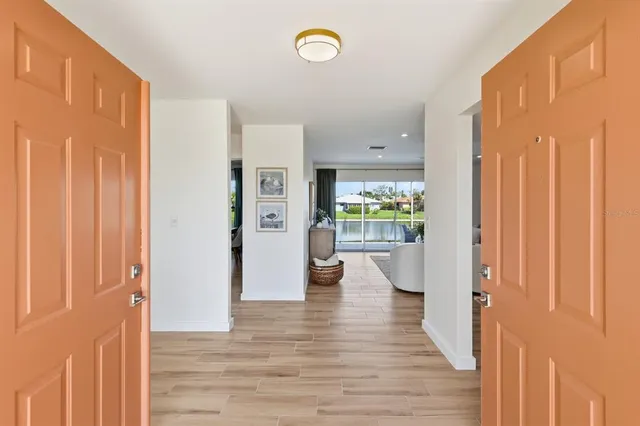 a view of an entryway with wooden floor and windows