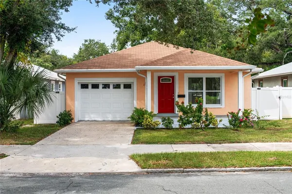a front view of a house with a garden