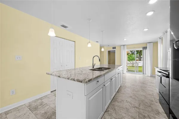 a kitchen with stainless steel appliances granite countertop a stove a refrigerator and a microwave