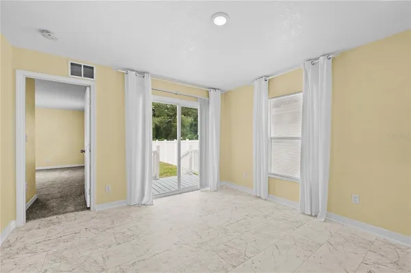 an empty room with a empty space and a ceiling fan