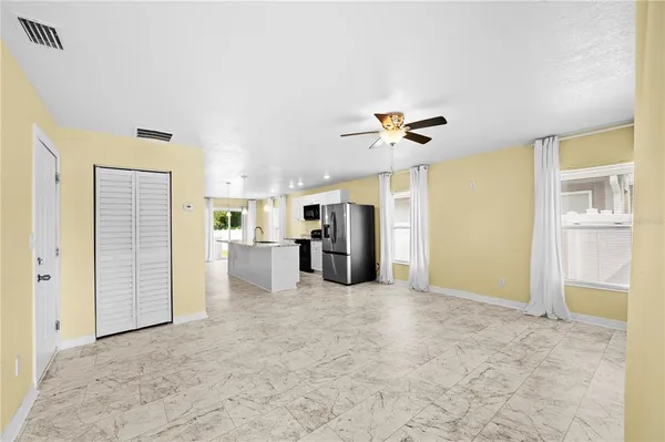 an empty room with windows and closet