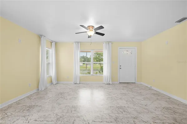 a large bathroom with a granite countertop sink and a large mirror