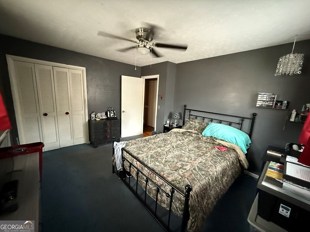 1158 Holly Grove Circle Northeast Dalton, GA 30721 - Photo 9 of 20 a bedroom with a bed and a chandelier