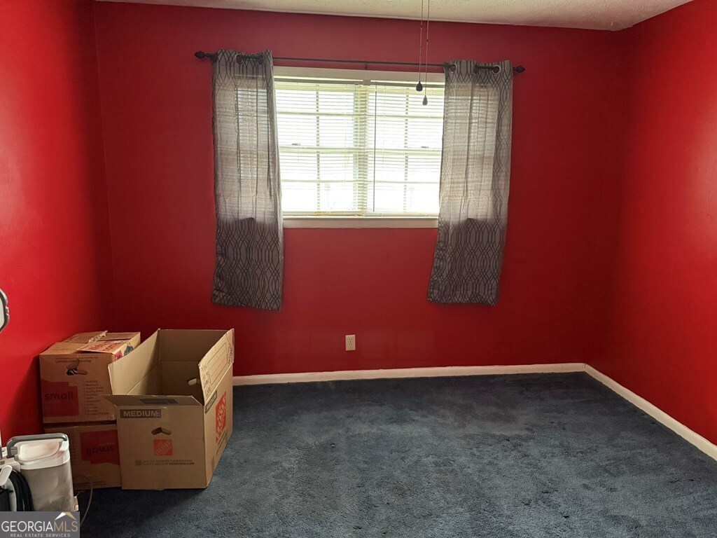 1158 Holly Grove Circle Northeast Dalton, GA 30721 - Photo 10 of 20 a room with a chair and a window