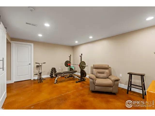 a living room with furniture a air conditioner vent and a rug