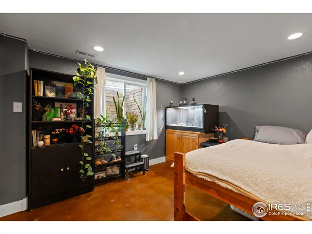 a bedroom with a bed closet and a large window