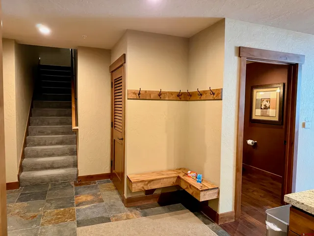 a room with stairs and a wooden door