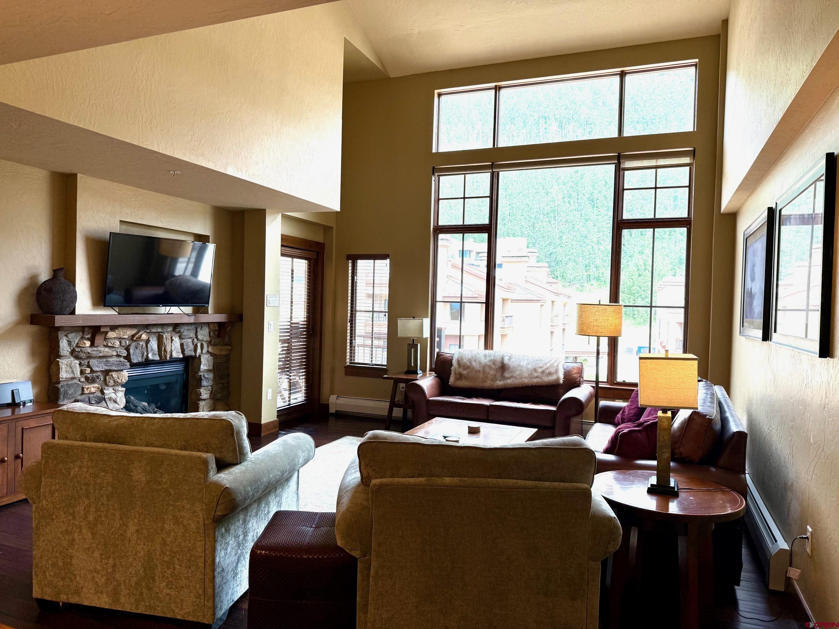 24 Sheol Street, Unit 506 Durango, CO 81301 - Photo 26 of 45 a living room with furniture a large window and a flat screen tv