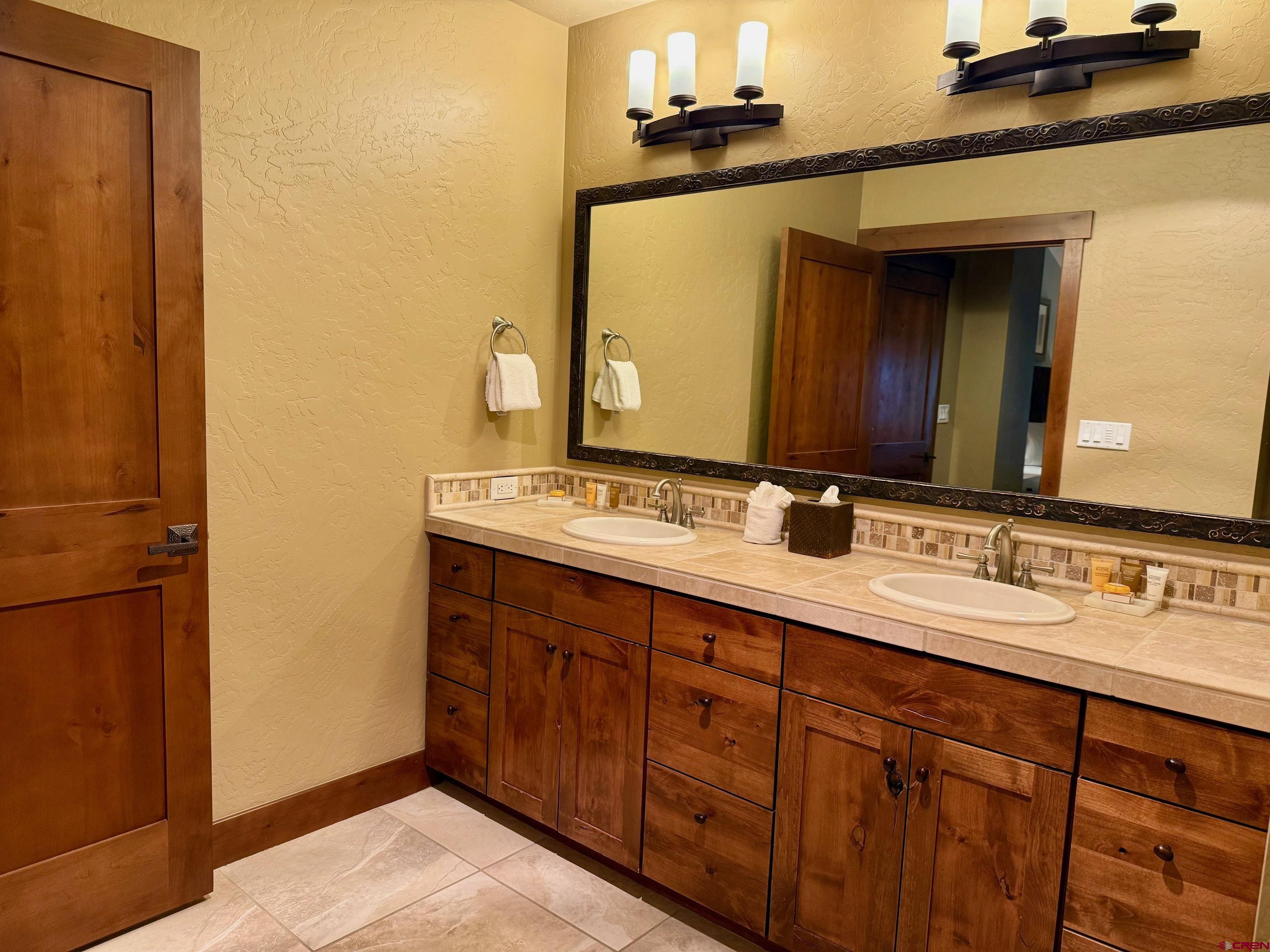 24 Sheol Street, Unit 506 Durango, CO 81301 - Photo 3 of 45 a bathroom with a double vanity sink and a mirror