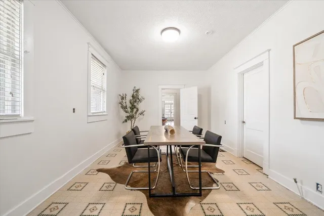a view of a dining room with furniture and window