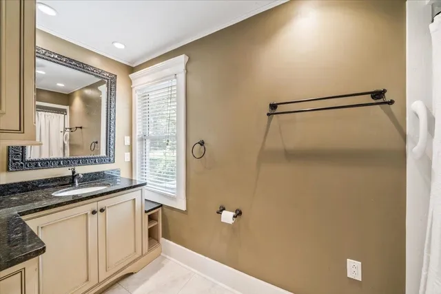 a bathroom with a granite countertop sink mirror and a shower
