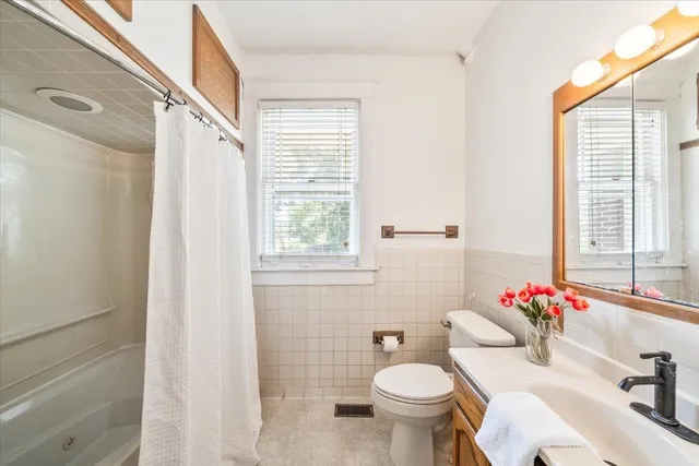 a bathroom with a sink toilet and a mirror