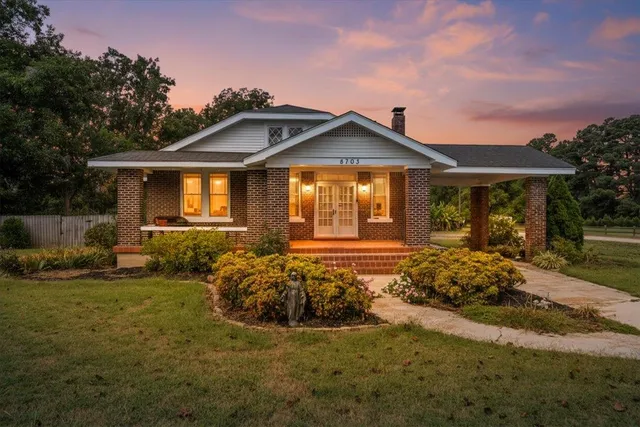 a front view of a house with a garden
