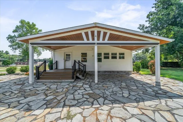 a view of a house with backyard porch and sitting area