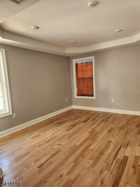 464 Walnut Street Elizabeth, NJ 07201 - Photo 15 of 22 an empty room with wooden floor and windows