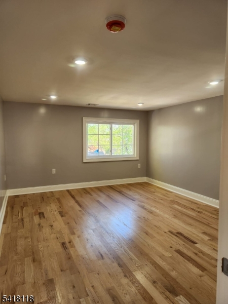 464 Walnut Street Elizabeth, NJ 07201 - Photo 18 of 22 an empty room with wooden floor and windows