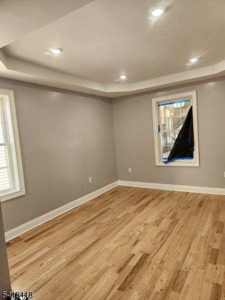 464 Walnut Street Elizabeth, NJ 07201 - Photo 19 of 22 an empty room with wooden floor and windows