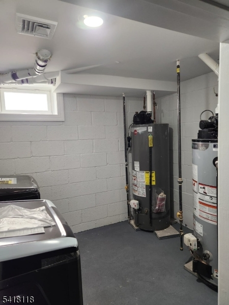 464 Walnut Street Elizabeth, NJ 07201 - Photo 8 of 22 a view of storage and utility room with refrigerator and toys