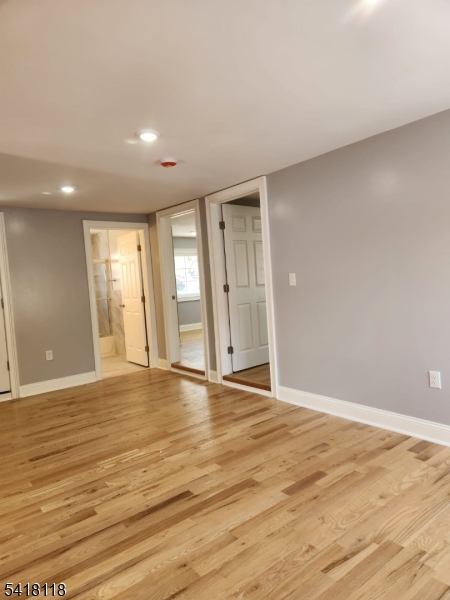 464 Walnut Street Elizabeth, NJ 07201 - Photo 10 of 22 a view of an empty room with wooden floor and windows