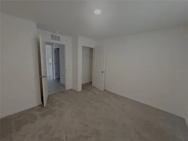 an empty room with closet area