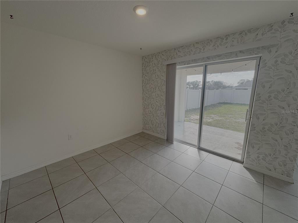 8940 Southwest 50th Terrace Ocala, FL 34476 - Photo 19 of 21 an empty room with sliding glass door