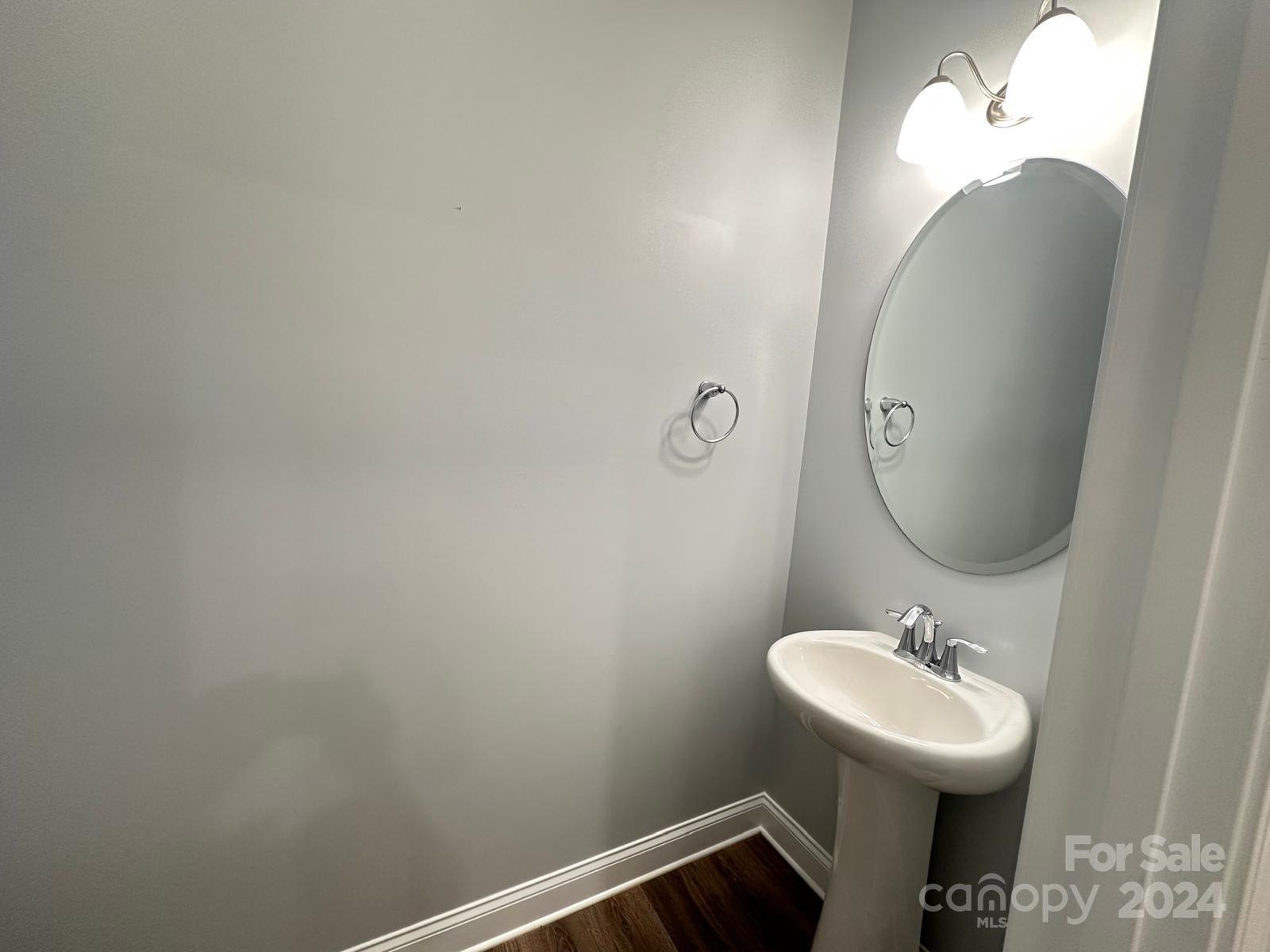 7040 Harris Bay Road Charlotte, NC 28269 - Photo 12 of 27 a bathroom with a sink and a mirror