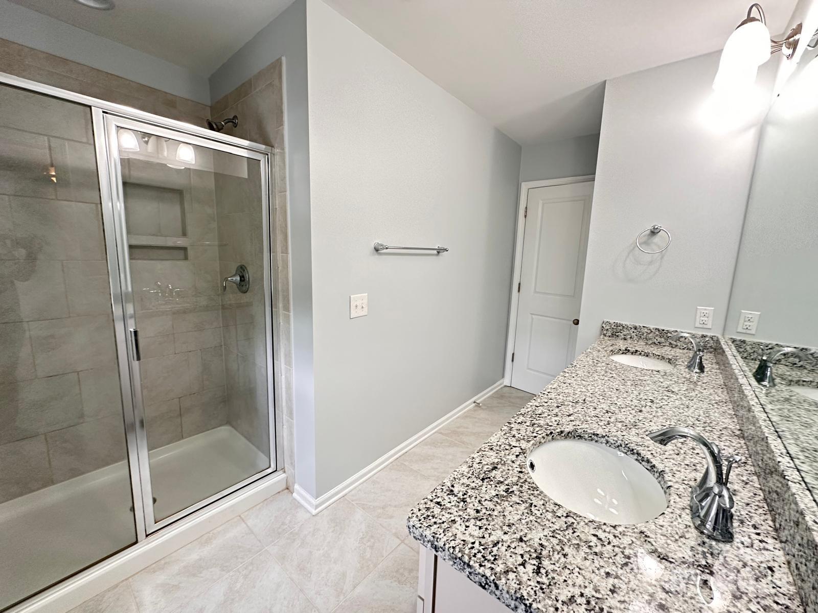7040 Harris Bay Road Charlotte, NC 28269 - Photo 17 of 27 a bathroom with a sink and a mirror