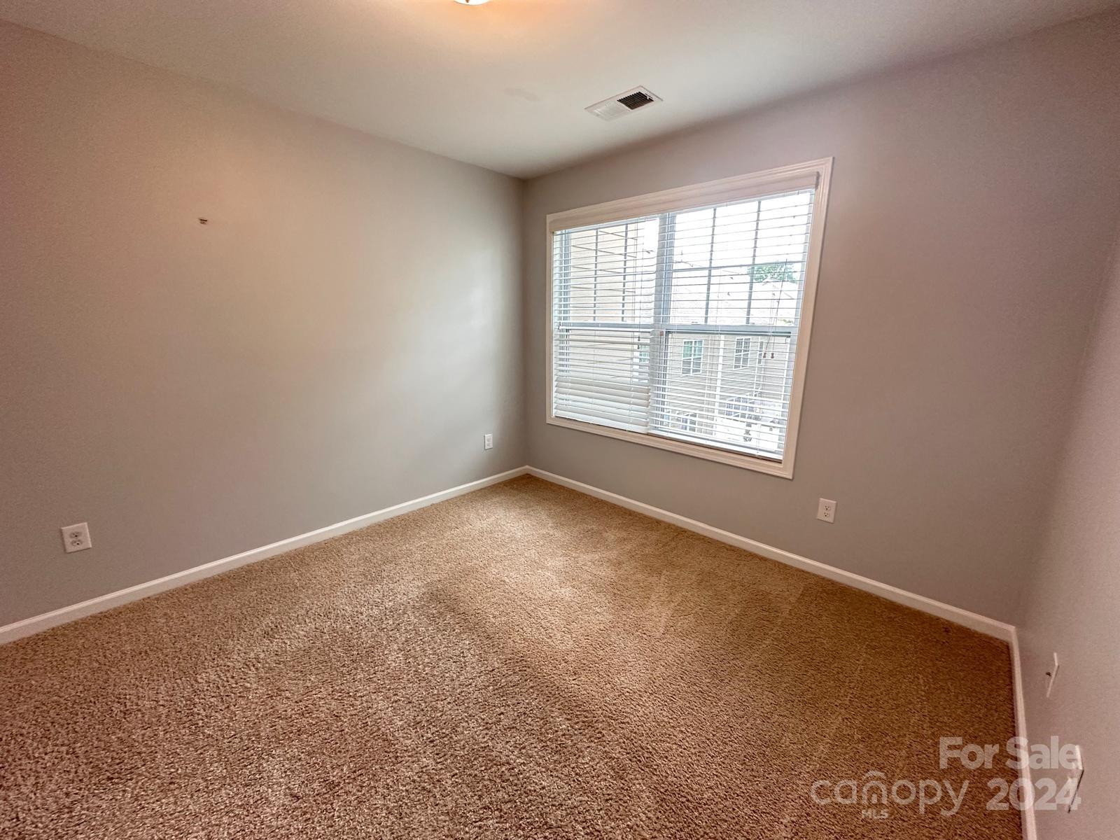 7040 Harris Bay Road Charlotte, NC 28269 - Photo 20 of 27 an empty room with a window