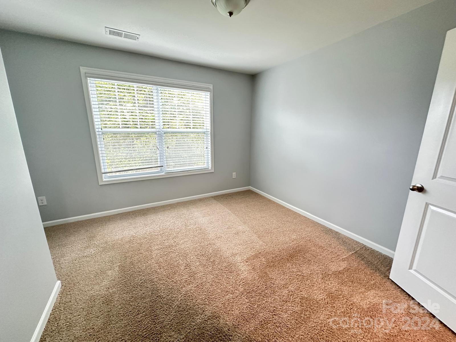 7040 Harris Bay Road Charlotte, NC 28269 - Photo 21 of 27 an empty room with a window