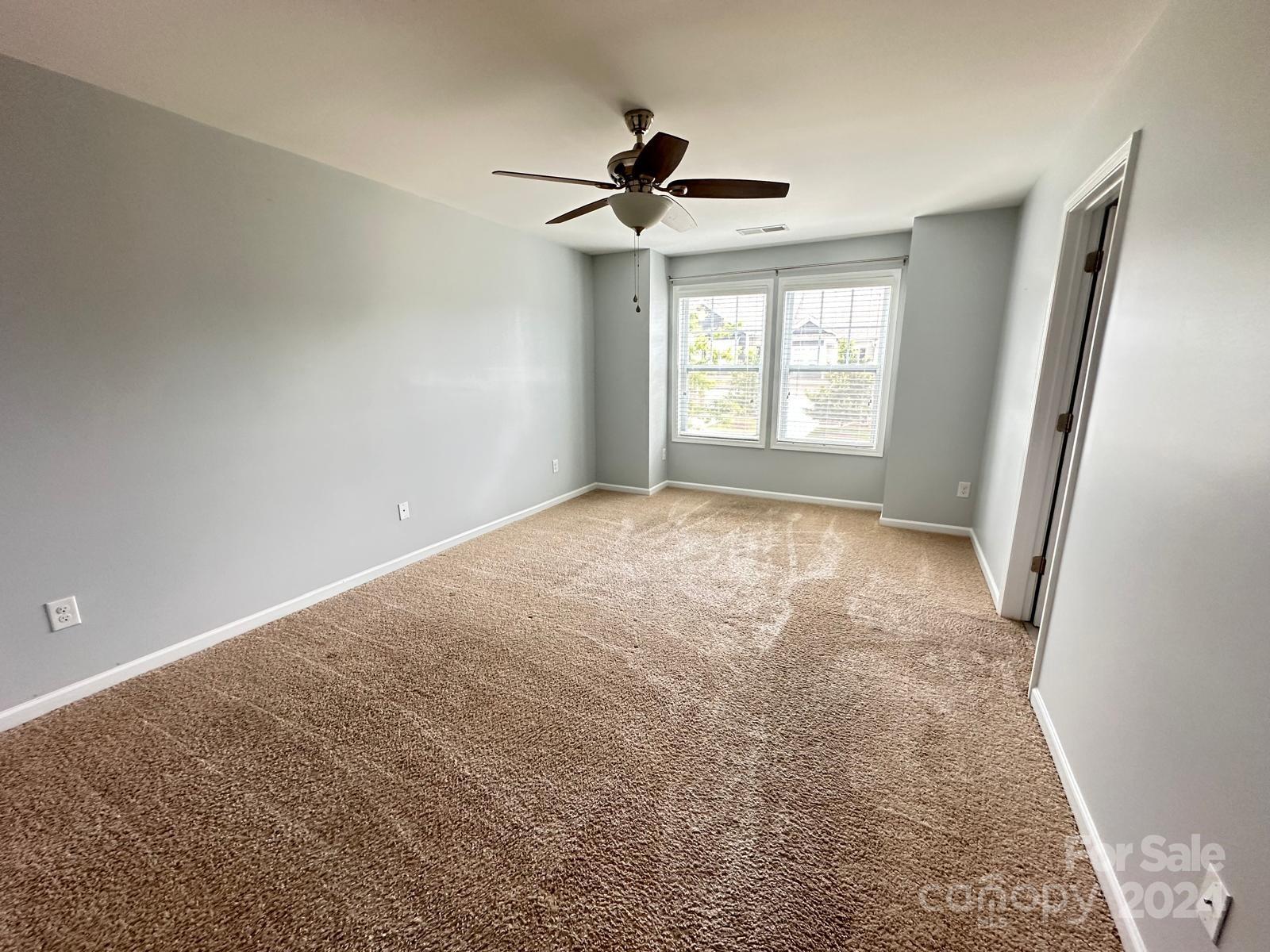 7040 Harris Bay Road Charlotte, NC 28269 - Photo 25 of 27 a view of room with a ceiling fan and window