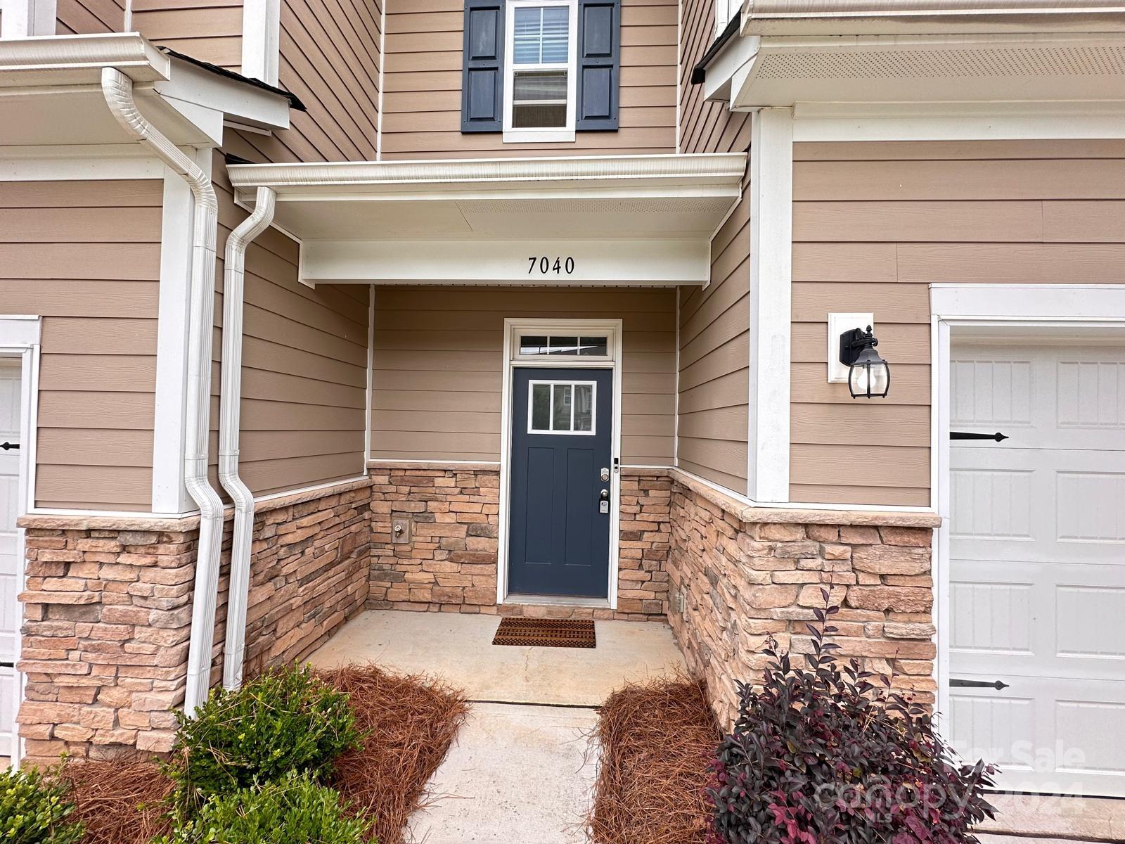 7040 Harris Bay Road Charlotte, NC 28269 - Photo 3 of 27 a front view of a house with a garage